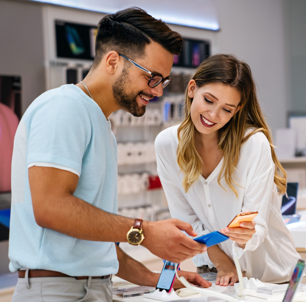 Couple examines phones in store.