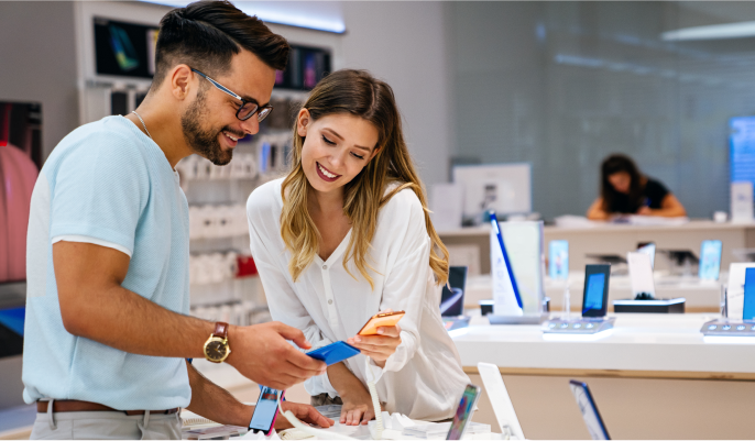 Couple examines phones in store.